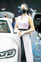Nonthaburi, Thailand - DEC 4, 2021 - Unidentified model poses with a car at The 38th Motor Expo Thailand 2021 at IMPACT Arena, Muang Thong Thani, Nonthaburi, Thailand. photo