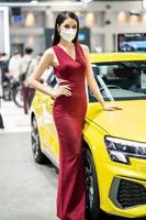 Nonthaburi, Thailand - DEC 4, 2021 - Unidentified model poses with a car at The 38th Motor Expo Thailand 2021 at IMPACT Arena, Muang Thong Thani, Nonthaburi, Thailand. photo