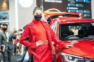 Nonthaburi, Thailand - DEC 4, 2021 - Unidentified model poses with a car at The 38th Motor Expo Thailand 2021 at IMPACT Arena, Muang Thong Thani, Nonthaburi, Thailand. photo