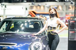 Nonthaburi, Thailand - DEC 4, 2021 - Unidentified model poses with a car at The 38th Motor Expo Thailand 2021 at IMPACT Arena, Muang Thong Thani, Nonthaburi, Thailand. photo