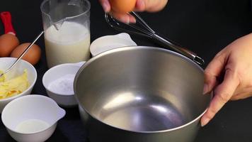 chef is breaking eggs into glass bowl, home bakery preparation concept video