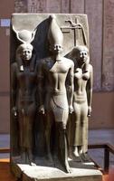Cairo, Egypt , March 18, 2023 Statue of King Menkaura, goddess Hathor and Bat. The Egyptian Museum in Cairo. photo