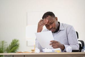 An American businessman with black skin in Africa feels uncomfortable at work and wrist pain is caused by the accumulated stress from failing to complete the job. and the body rests a little. photo