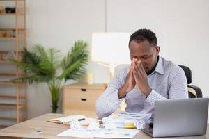 An American businessman with black skin in Africa feels uncomfortable at work and wrist pain is caused by the accumulated stress from failing to complete the job. and the body rests a little. photo