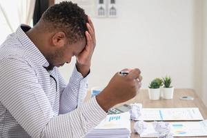 An American businessman with black skin in Africa feels uncomfortable at work and wrist pain is caused by the accumulated stress from failing to complete the job. and the body rests a little. photo