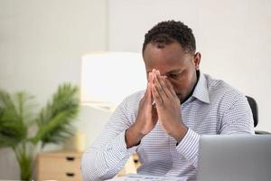 An American businessman with black skin in Africa feels uncomfortable at work and wrist pain is caused by the accumulated stress from failing to complete the job. and the body rests a little. photo