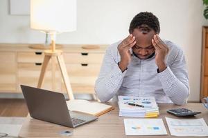 An American businessman with black skin in Africa feels uncomfortable at work and wrist pain is caused by the accumulated stress from failing to complete the job. and the body rests a little. photo