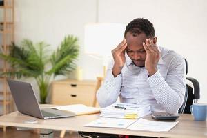 An American businessman with black skin in Africa feels uncomfortable at work and wrist pain is caused by the accumulated stress from failing to complete the job. and the body rests a little. photo