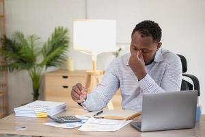 An American businessman with black skin in Africa feels uncomfortable at work and wrist pain is caused by the accumulated stress from failing to complete the job. and the body rests a little. photo