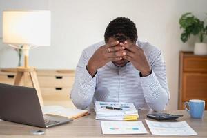 An American businessman with black skin in Africa feels uncomfortable at work and wrist pain is caused by the accumulated stress from failing to complete the job. and the body rests a little. photo
