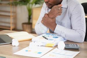 An American businessman with black skin in Africa feels uncomfortable at work and wrist pain is caused by the accumulated stress from failing to complete the job. and the body rests a little. photo