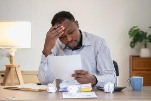 An American businessman with black skin in Africa feels uncomfortable at work and wrist pain is caused by the accumulated stress from failing to complete the job. and the body rests a little. photo