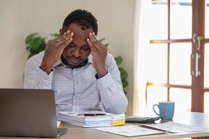 An American businessman with black skin in Africa feels uncomfortable at work and wrist pain is caused by the accumulated stress from failing to complete the job. and the body rests a little. photo