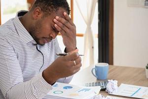 An American businessman with black skin in Africa feels uncomfortable at work and wrist pain is caused by the accumulated stress from failing to complete the job. and the body rests a little. photo