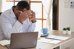 An American businessman with black skin in Africa feels uncomfortable at work and wrist pain is caused by the accumulated stress from failing to complete the job. and the body rests a little. photo