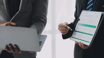 Financial analysts analyze business financial reports on a digital tablet planning investment project during a discussion at a meeting of corporate showing the results of their successful teamwork. video