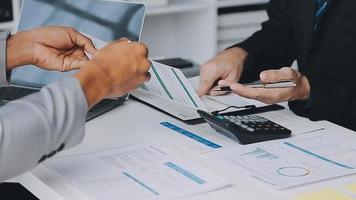 Financial analysts analyze business financial reports on a digital tablet planning investment project during a discussion at a meeting of corporate showing the results of their successful teamwork. video