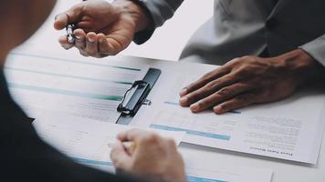Financial analysts analyze business financial reports on a digital tablet planning investment project during a discussion at a meeting of corporate showing the results of their successful teamwork. video