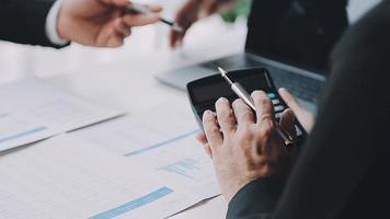 Financial analysts analyze business financial reports on a digital tablet planning investment project during a discussion at a meeting of corporate showing the results of their successful teamwork. video