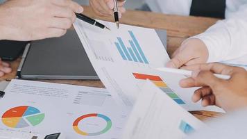 Financial analysts analyze business financial reports on a digital tablet planning investment project during a discussion at a meeting of corporate showing the results of their successful teamwork. video