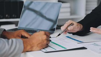 Financial analysts analyze business financial reports on a digital tablet planning investment project during a discussion at a meeting of corporate showing the results of their successful teamwork. video
