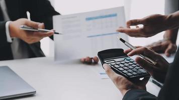 Financial analysts analyze business financial reports on a digital tablet planning investment project during a discussion at a meeting of corporate showing the results of their successful teamwork. video