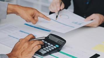 Financial analysts analyze business financial reports on a digital tablet planning investment project during a discussion at a meeting of corporate showing the results of their successful teamwork. video