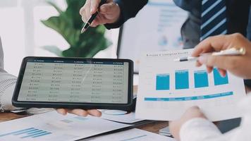 Financial analysts analyze business financial reports on a digital tablet planning investment project during a discussion at a meeting of corporate showing the results of their successful teamwork. video