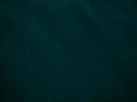 Dark green old velvet fabric texture used as background. Empty green fabric background of soft and smooth textile material. There is space for text.. photo