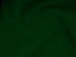 Dark green old velvet fabric texture used as background. Empty green fabric background of soft and smooth textile material. There is space for text.. photo