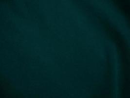 Dark green old velvet fabric texture used as background. Empty green fabric background of soft and smooth textile material. There is space for text.. photo