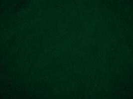 Dark green old velvet fabric texture used as background. Empty green fabric background of soft and smooth textile material. There is space for text.. photo