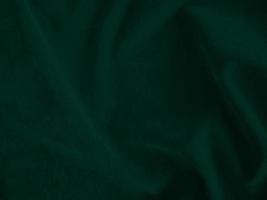 Dark green old velvet fabric texture used as background. Empty green fabric background of soft and smooth textile material. There is space for text.. photo