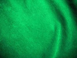 Dark green old velvet fabric texture used as background. Empty green fabric background of soft and smooth textile material. There is space for text.. photo