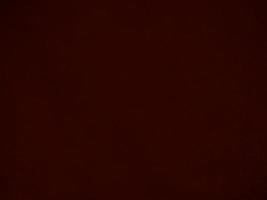 Dark red velvet fabric texture used as background. Empty dark red fabric background of soft and smooth textile material. There is space for text. photo