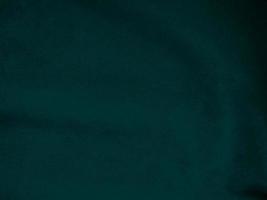 Dark green old velvet fabric texture used as background. Empty green fabric background of soft and smooth textile material. There is space for text.. photo