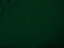 Dark green old velvet fabric texture used as background. Empty green fabric background of soft and smooth textile material. There is space for text.. photo