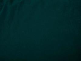 Dark green old velvet fabric texture used as background. Empty green fabric background of soft and smooth textile material. There is space for text.. photo