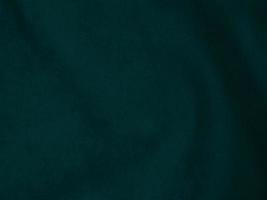 Dark green old velvet fabric texture used as background. Empty green fabric background of soft and smooth textile material. There is space for text.. photo
