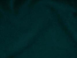 Dark green old velvet fabric texture used as background. Empty green fabric background of soft and smooth textile material. There is space for text.. photo