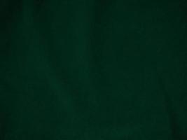 Dark green old velvet fabric texture used as background. Empty green fabric background of soft and smooth textile material. There is space for text.. photo