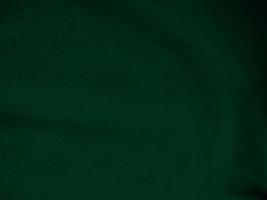 Dark green old velvet fabric texture used as background. Empty green fabric background of soft and smooth textile material. There is space for text.. photo