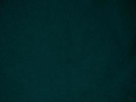 Dark green old velvet fabric texture used as background. Empty green fabric background of soft and smooth textile material. There is space for text.. photo