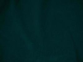 Dark green old velvet fabric texture used as background. Empty green fabric background of soft and smooth textile material. There is space for text.. photo