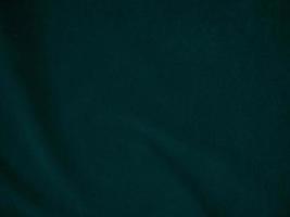 Dark green old velvet fabric texture used as background. Empty green fabric background of soft and smooth textile material. There is space for text.. photo