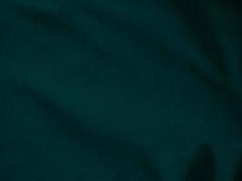 Dark green old velvet fabric texture used as background. Empty green fabric background of soft and smooth textile material. There is space for text.. photo