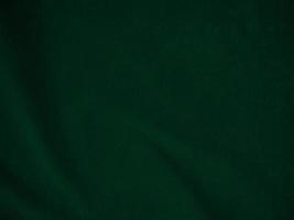 Dark green old velvet fabric texture used as background. Empty green fabric background of soft and smooth textile material. There is space for text.. photo