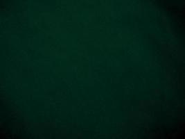 Dark green old velvet fabric texture used as background. Empty green fabric background of soft and smooth textile material. There is space for text.. photo