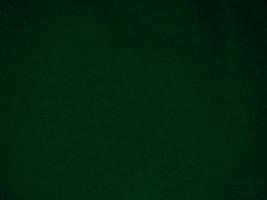 Dark green old velvet fabric texture used as background. Empty green fabric background of soft and smooth textile material. There is space for text.. photo