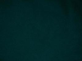 Dark green old velvet fabric texture used as background. Empty green fabric background of soft and smooth textile material. There is space for text.. photo